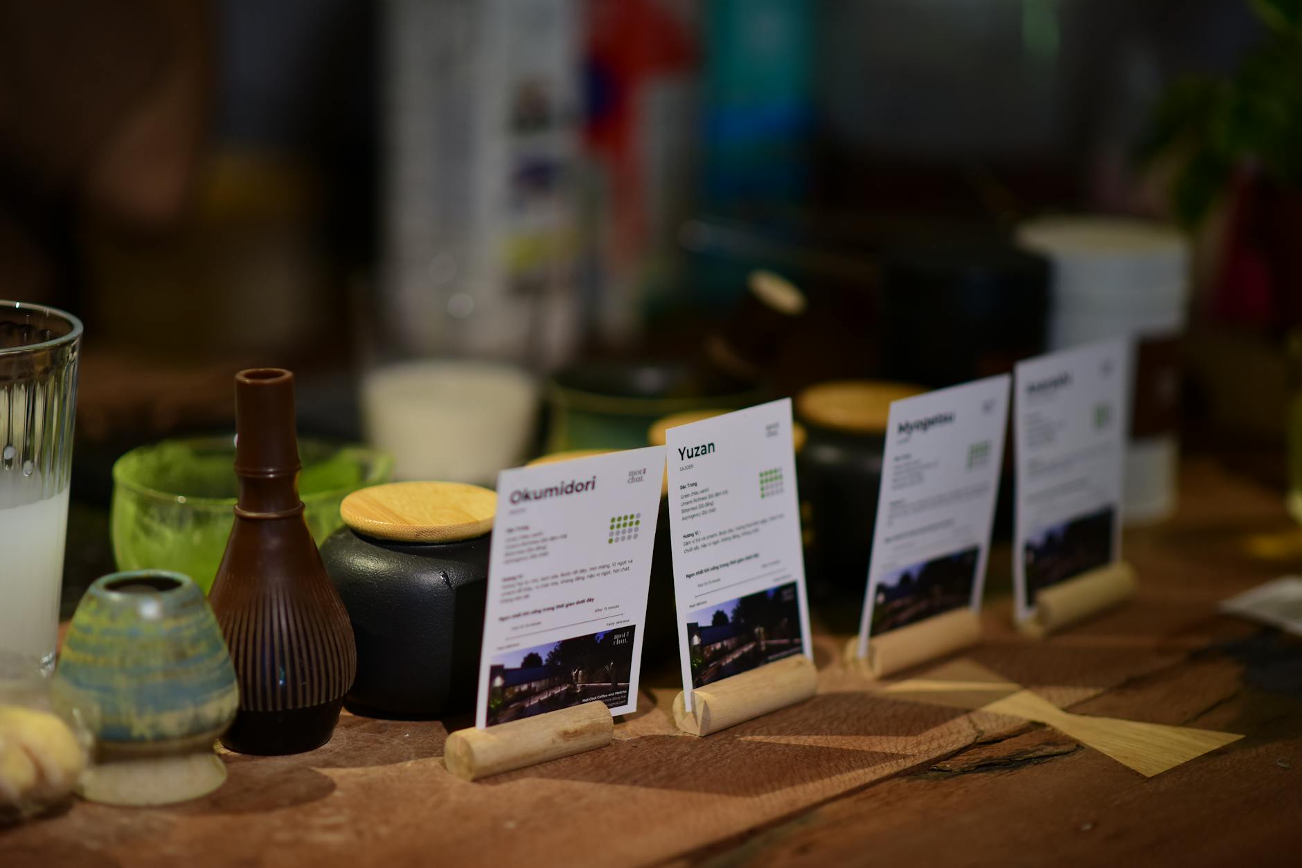 Degustacja japońskiej herbaty z opisanymi kartami na drewnianym stole